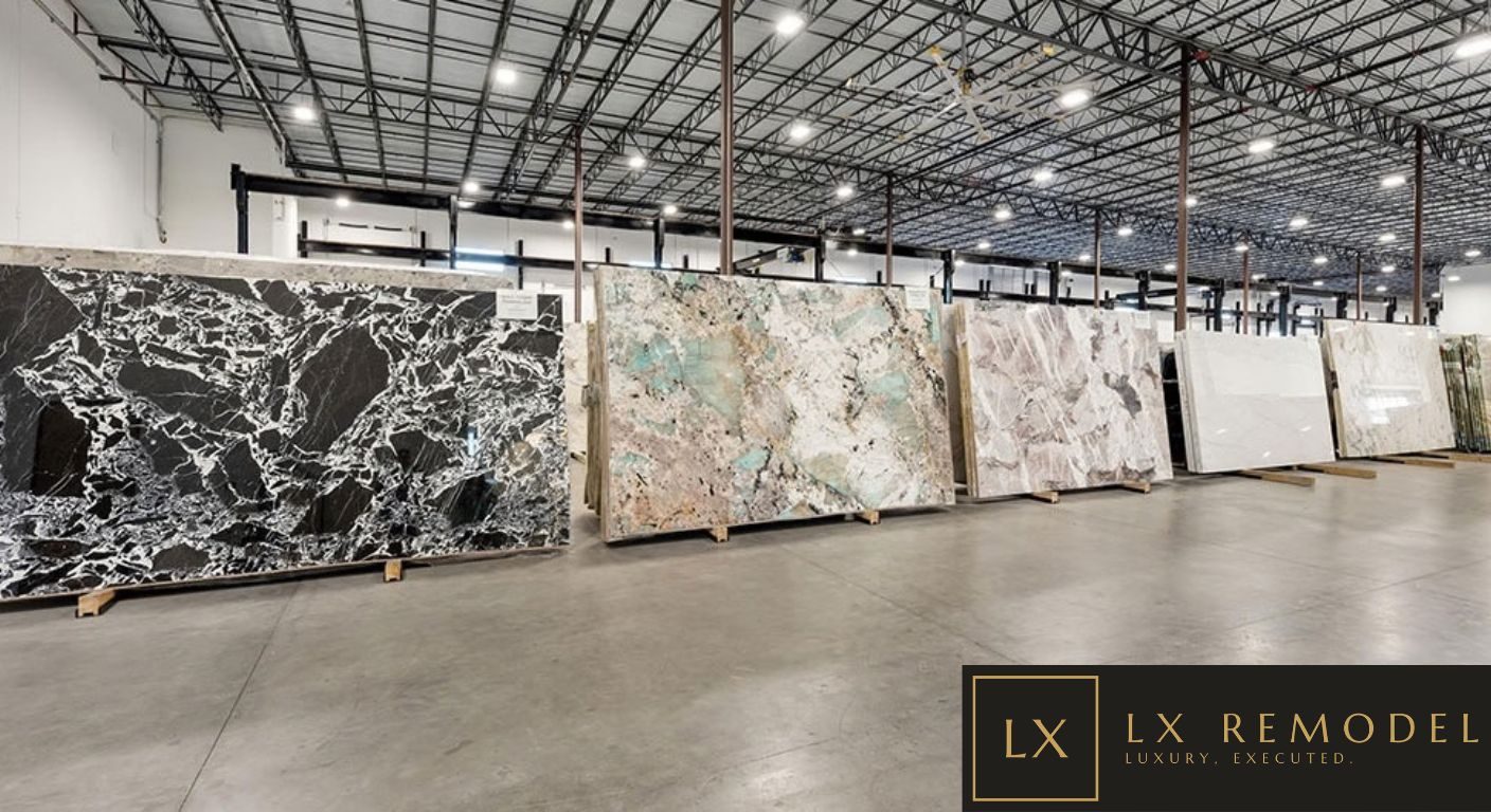 Stone gallery with full slabs standing on racks, including black and white marble and green quartzite, viewed full size before fabrication